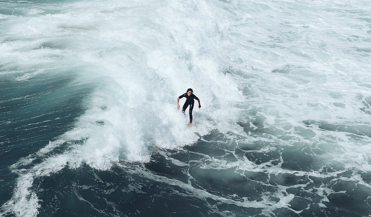 Surfers riding waves off Huntington Beach